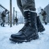 Person in winter gear wearing JHB07 heated tactical boots during training in deep snow