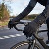 Man wearing JHG43 heated gloves riding a road bike in cold winter weather