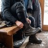 JHS07 Heated Socks - Outdoor Boots Lifestyle Man putting on winter boots over JHS07 heated socks for outdoor use